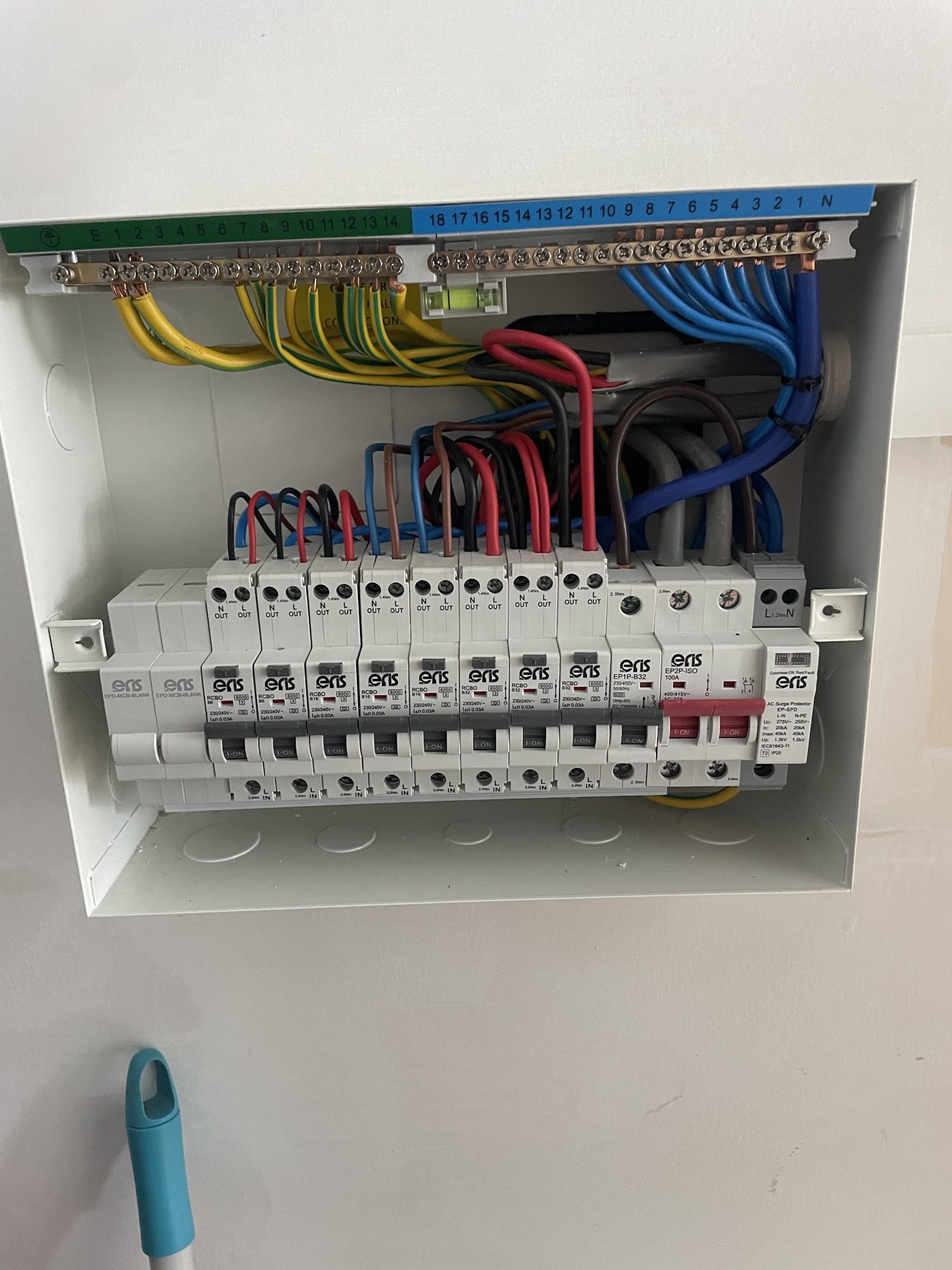 A consumer unit with neat, colour-coded wiring