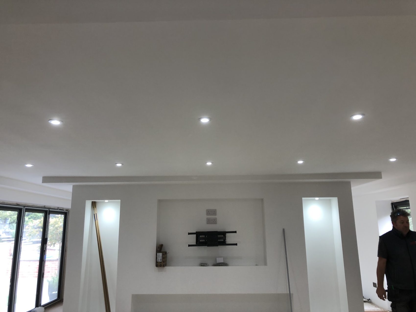 Downlights and a lit alcove above a television recess